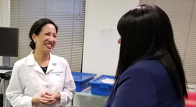 Dr. Simma-Chiang talking to a patient