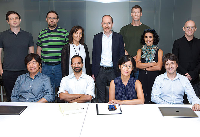 A photo showing Sacha Gnjatic, PhD, and Miriam Merad, MD, PhD, with team of Mount Sinai researchers