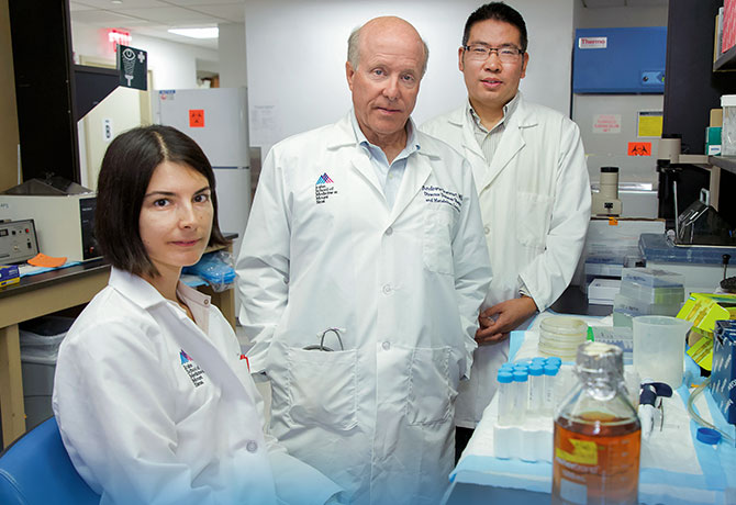 A photo of Andrew F. Stewart, MD, center, with team members Esra Karakose, PhD, and Peng Wang, PhD