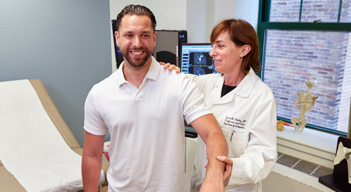 Image of orthopedic surgeon and system chair, Dr. Leesa Galatz with male shoulder patient.